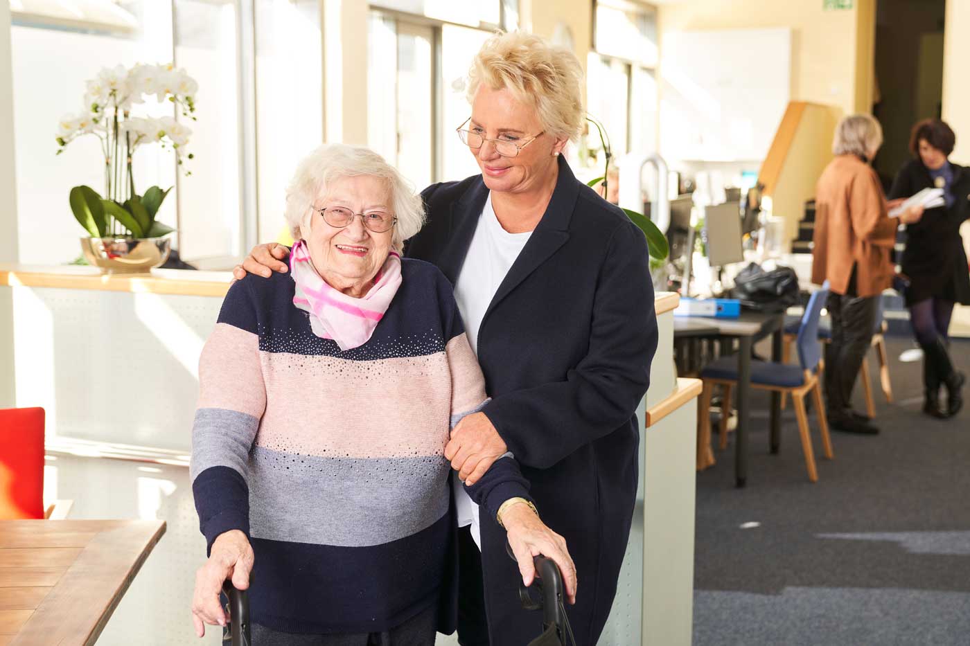 Eine Frau hält die Schulter einer Frau.
